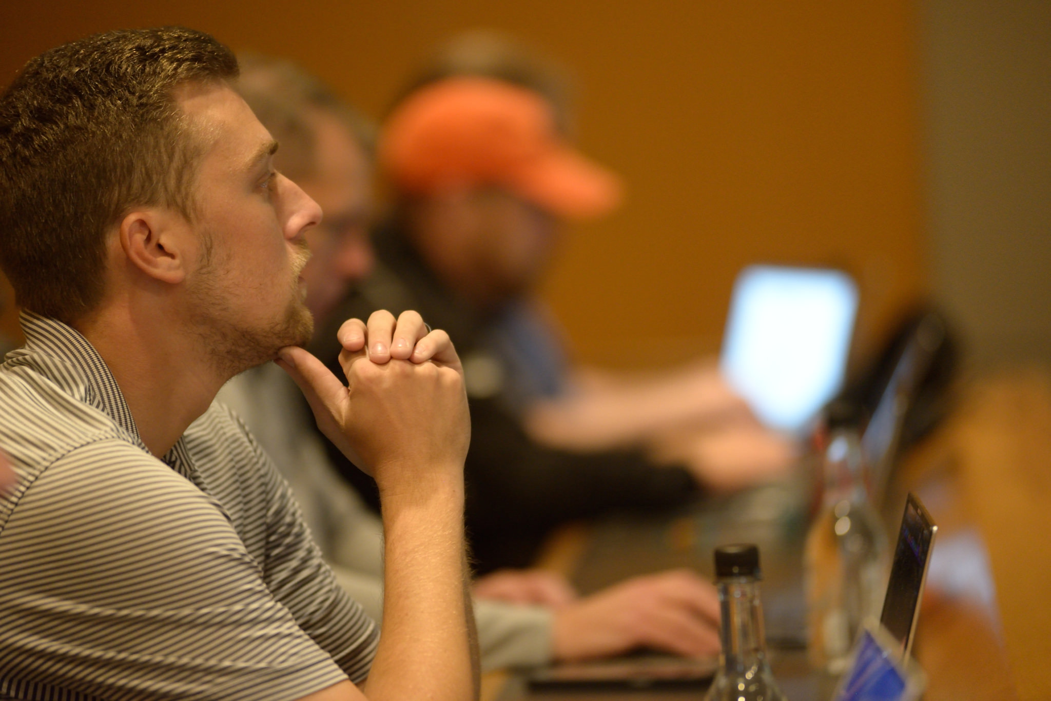 Connor Baumann sitting at a table watching the ThoughtSpot presentation