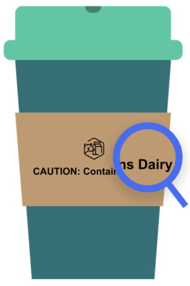 A coffee cup whose sleeve says "Caution: Contains Dairy"