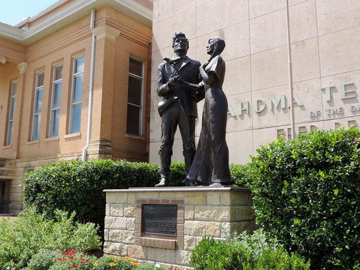 A bronze statue of a Native couple