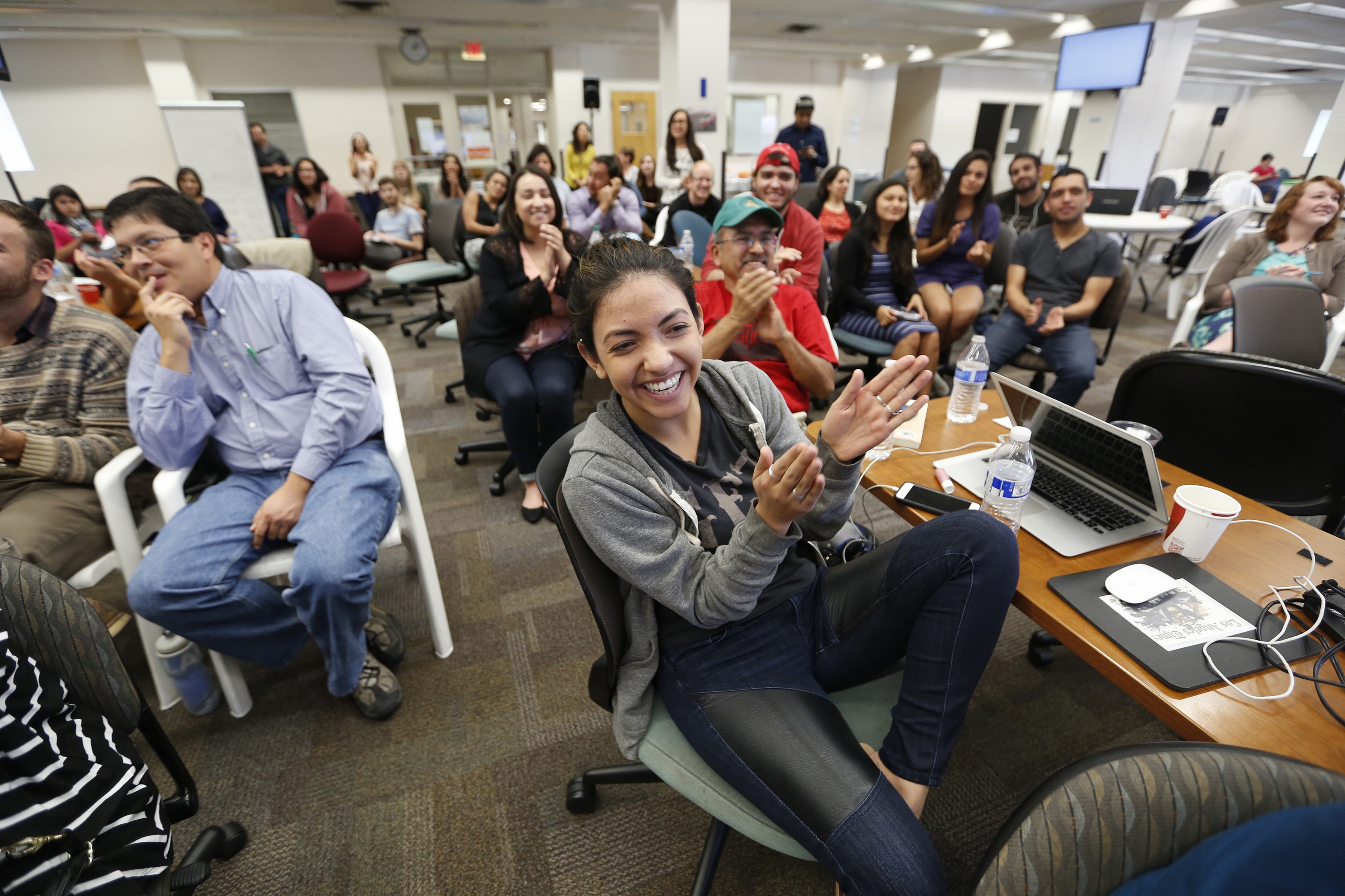 Migrahack attendees applauding a presentation